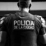 Black and white image of a Buenos Aires city police officer in uniform, reflecting urban security.