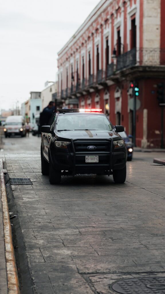 A police car on a historic city street with vintage architecture and urban ambiance.