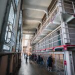Visitors explore the historic cell blocks of Alcatraz prison, San Francisco.